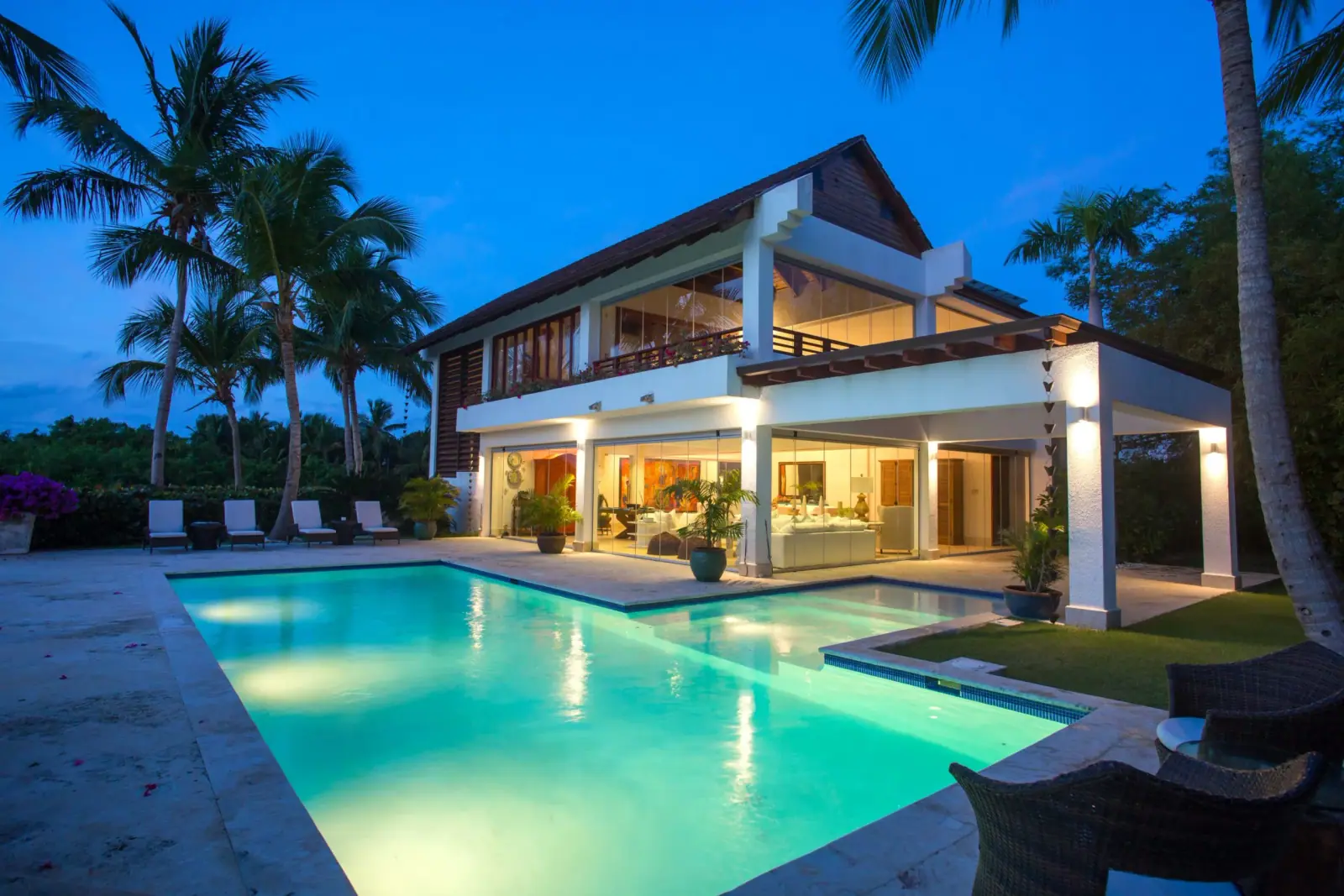 A private villa with infinity pool lit at dusk in the Caribbean