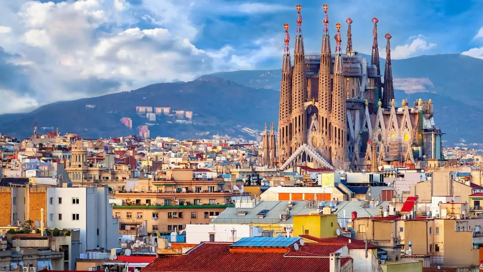 The spires of La Sagrada Familia rising above the rooftops of Barcelona