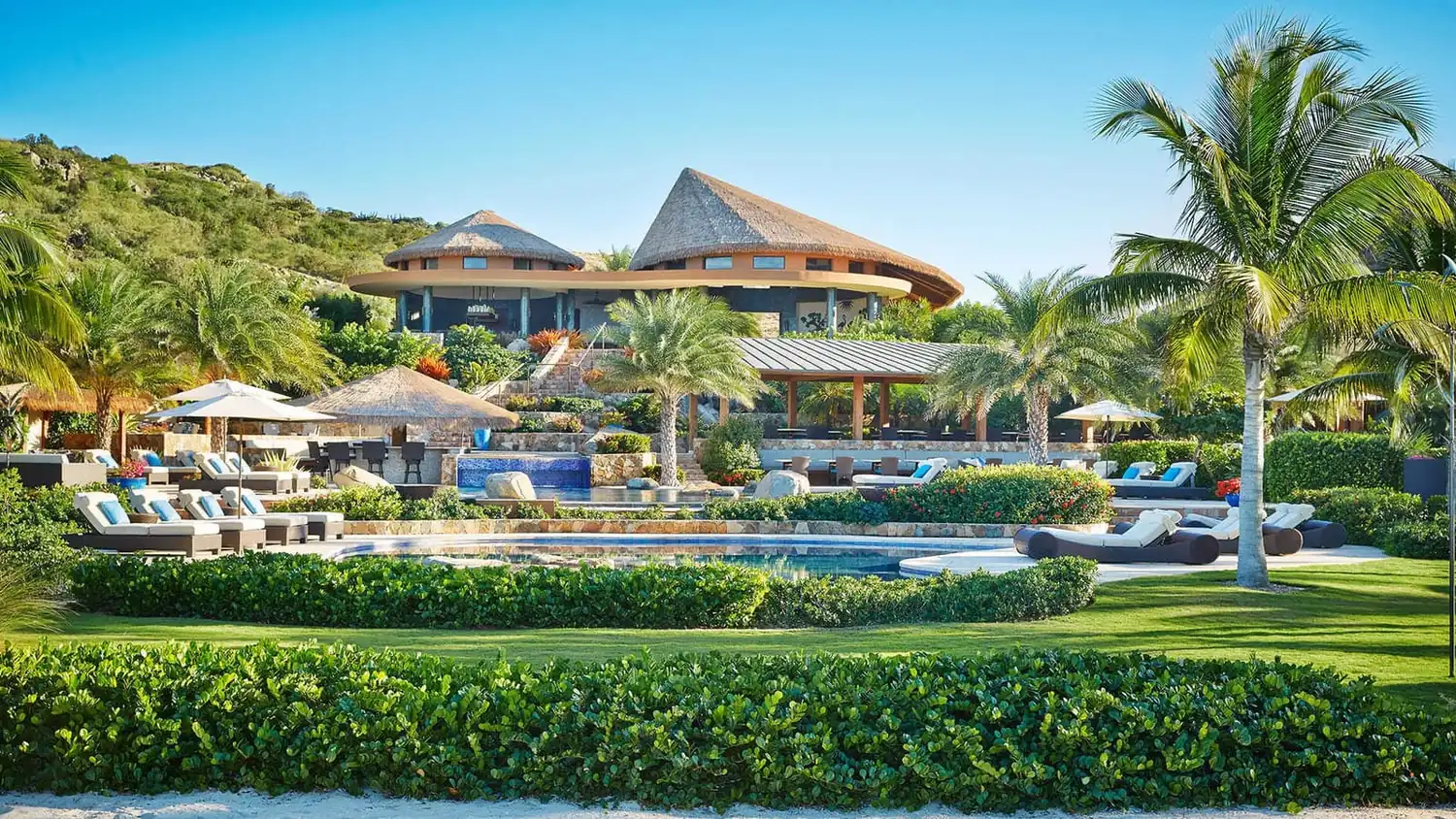 The Beach Club at Oil Nut Bay on Virgin Gorda, BVI, framed by palms