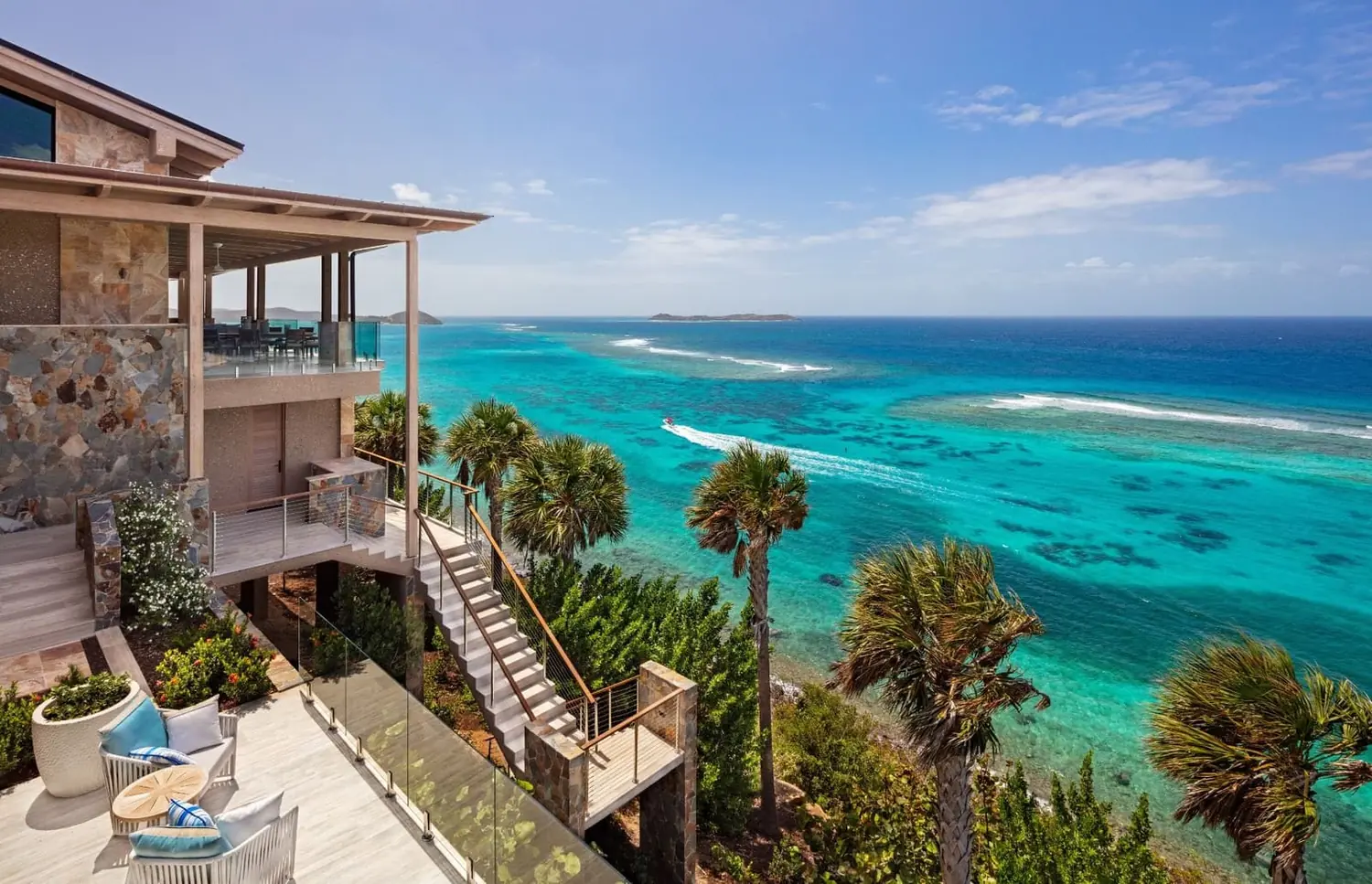 Cliffside villa overlooking turquoise Caribbean reefs and the open sea