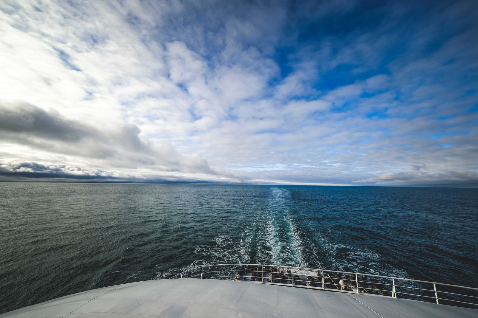 Open ocean and the ship's wake seen from a cruise deck