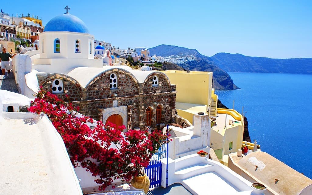 Whitewashed clifftop village above the blue Aegean Sea on Santorini, Greece