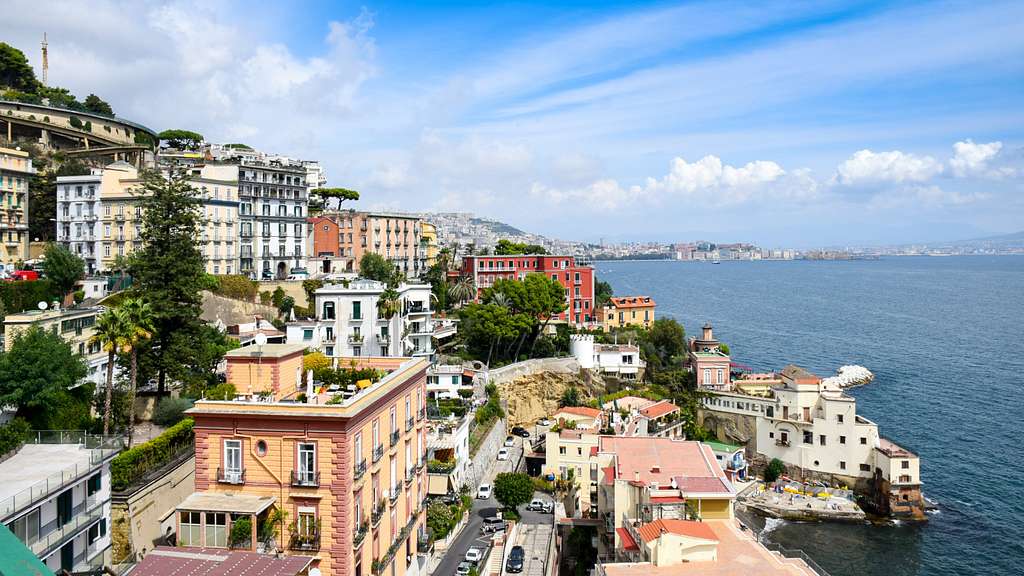 The pastel cliffside neighborhoods of Naples descending to the Tyrrhenian Sea