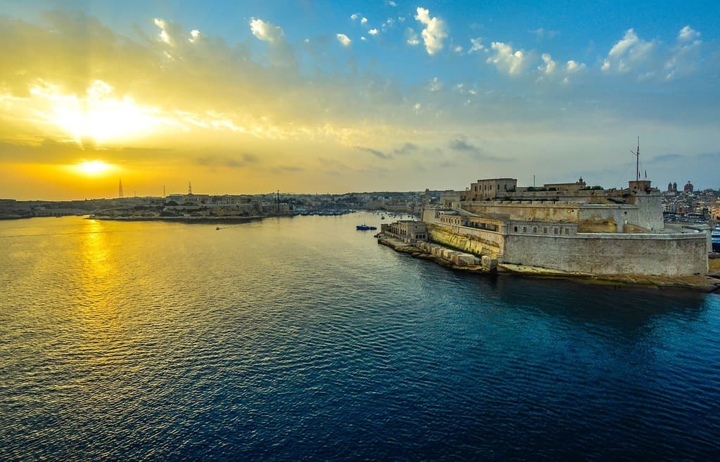 The Grand Harbour of Valletta, Malta at golden hour with limestone fortifications